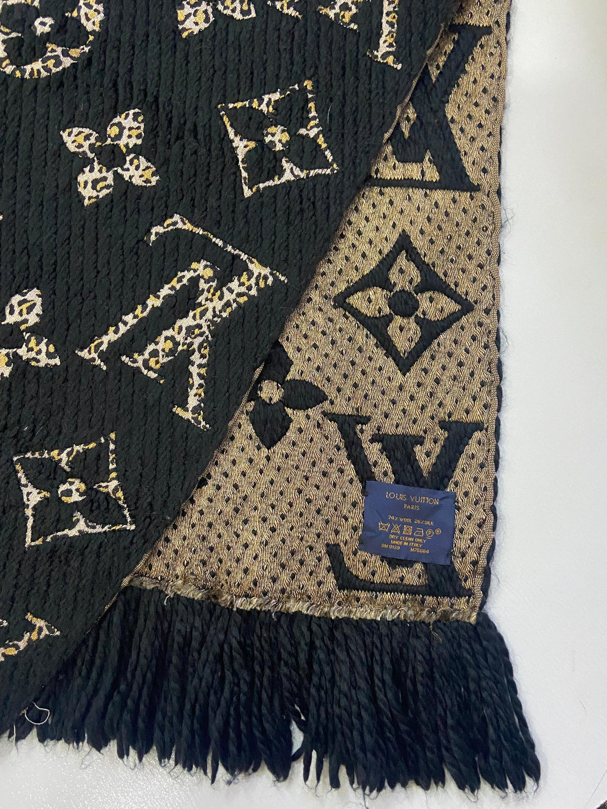 Close-up of jacquard weave texture and fringe edge on Louis Vuitton M75884 Jungle Scarf